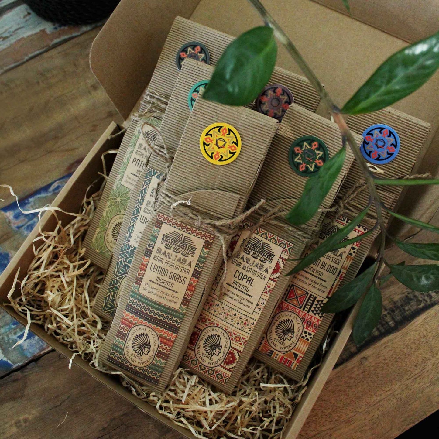 Box of incense sticks with decorative labels on a wooden surface