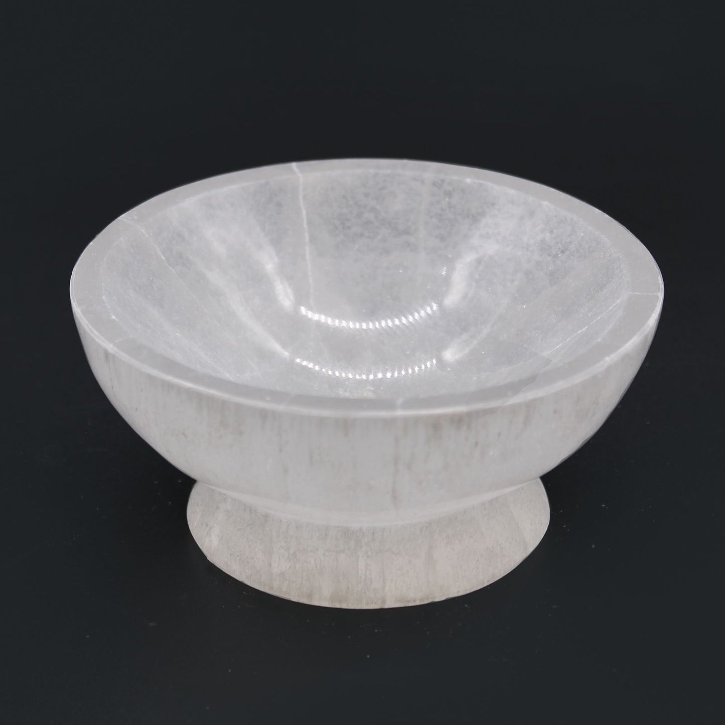 White marble bowl on a black background