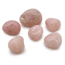 Close-up of smooth, polished Rose Quartz tumbled stones showcasing their soft pink hues and natural beauty.
