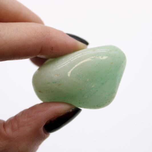A close-up image of the Aventurine tumble stones, highlighting their vibrant green color and unique textures, symbolizing prosperity and emotional healing.