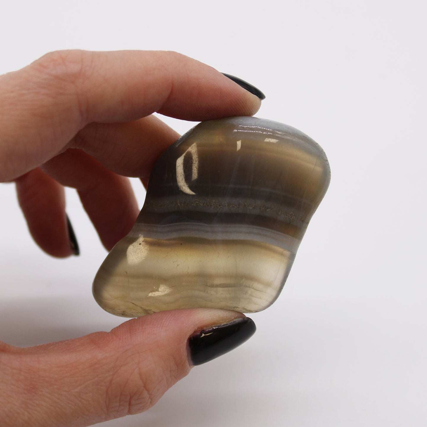 Close-up image of Grey Agate Tumbled Stones, showcasing their smooth texture and natural patterns. Perfect for healing, meditation, and spiritual balance.