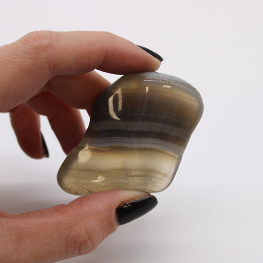 Close-up image of Grey Agate Tumbled Stones, showcasing their smooth texture and natural patterns. Perfect for healing, meditation, and spiritual balance.