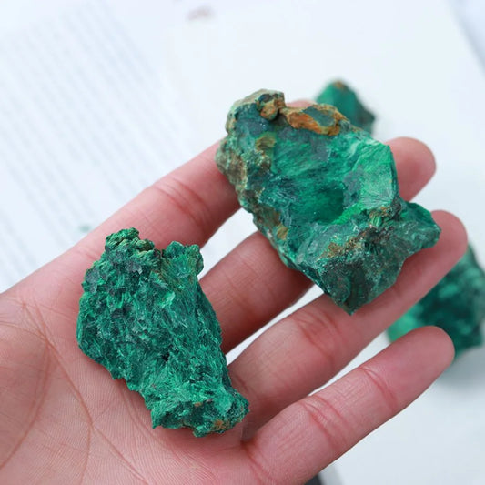 Natural Green Malachite Crystal displayed as a raw mineral specimen, highlighting its intricate patterns and earthy green tones for spiritual and decorative use.