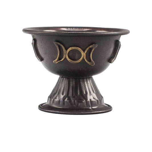 Black ceramic bowl with gold moon phase design on a white background
