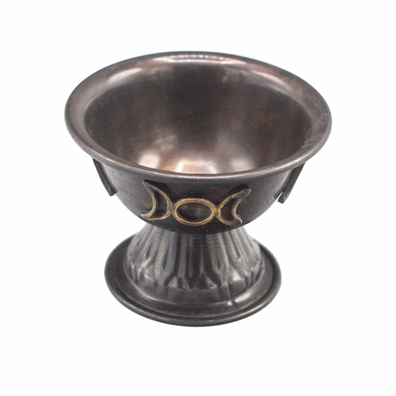 Decorative metal bowl with a three-phase moon symbol on a white background