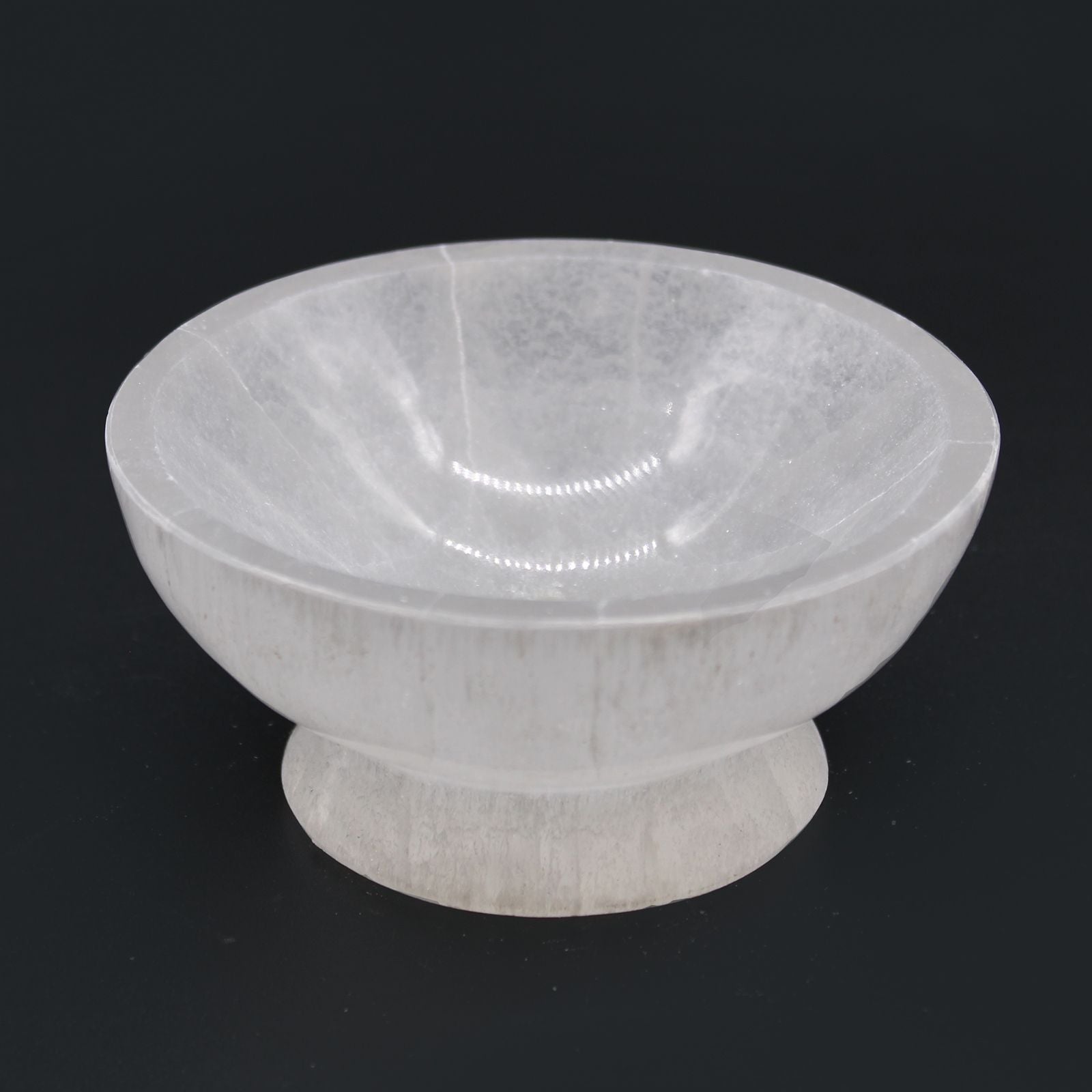 White marble bowl on a black background