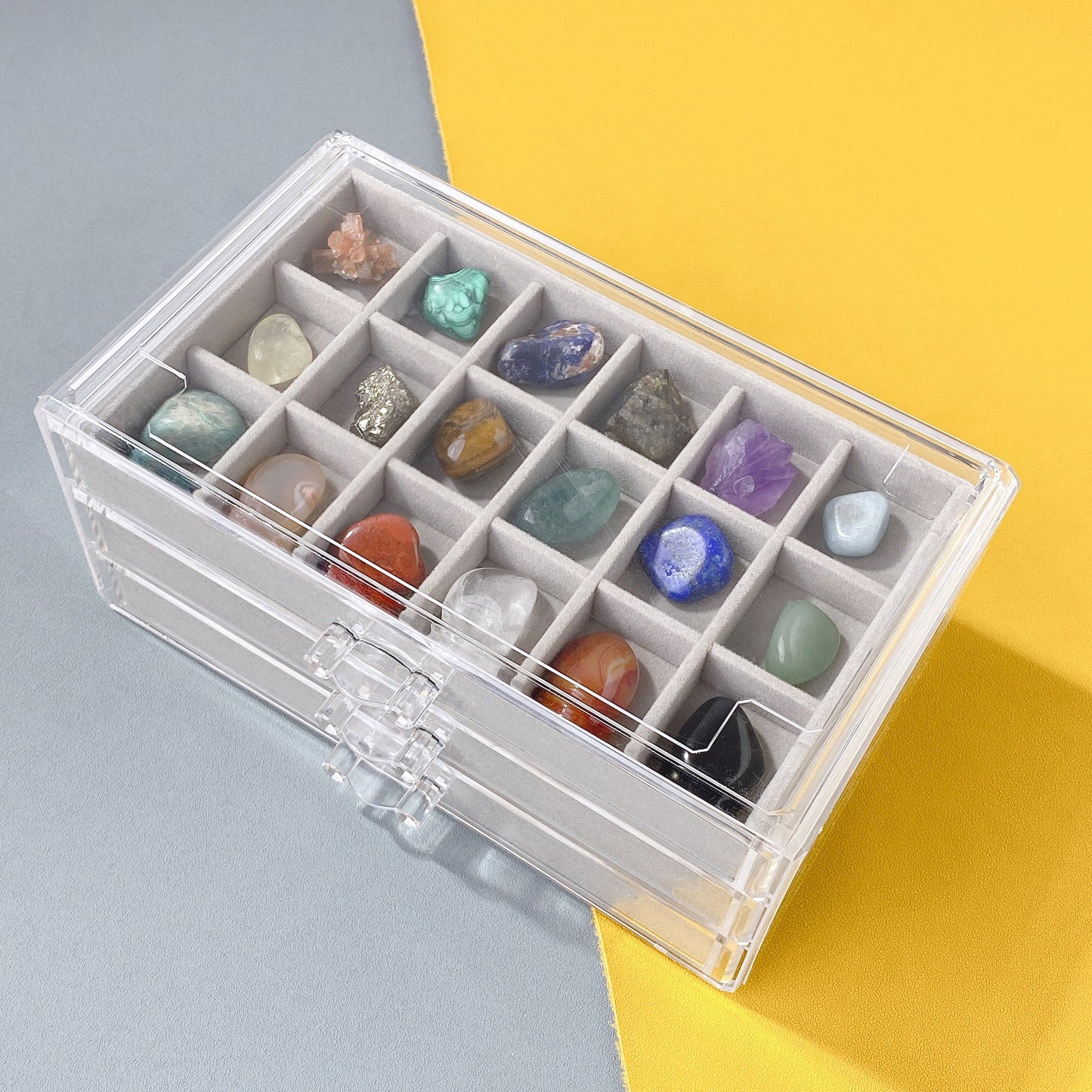 Assortment of natural crystal gemstones displayed from the specimen collection box